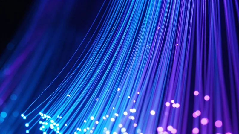 Optimizing Throughput for High-Traffic Global Data Centers Abstract visualization of massive data streams flowing through digital network nodes at high speed.